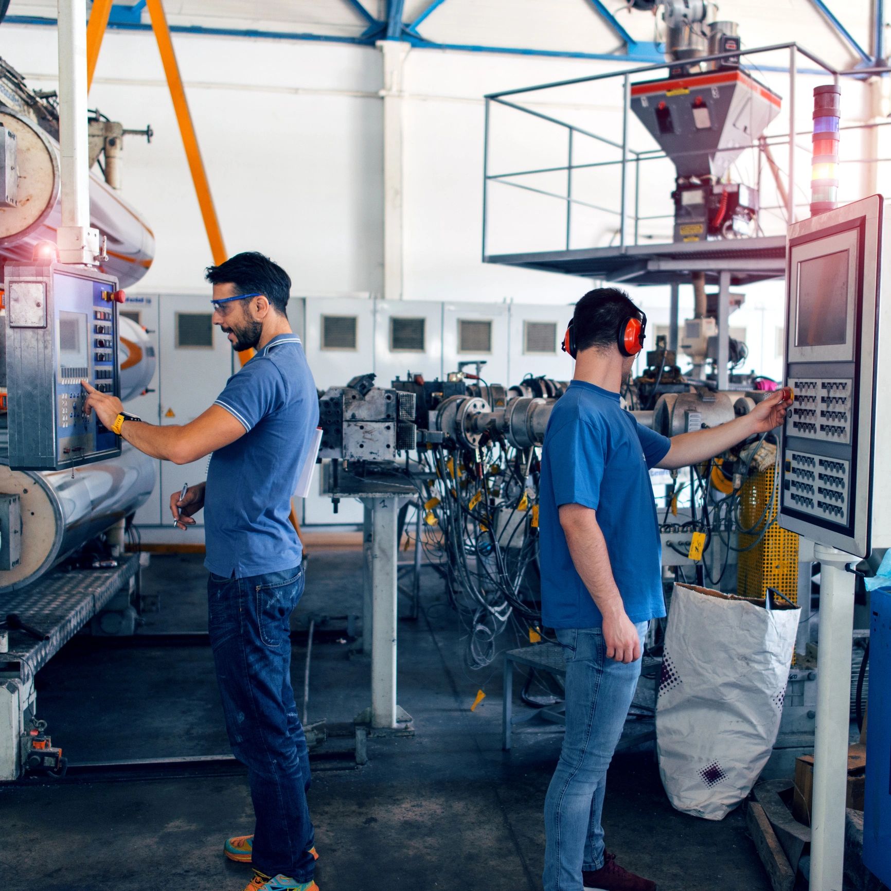 Industrial workers operating machinery in a factory